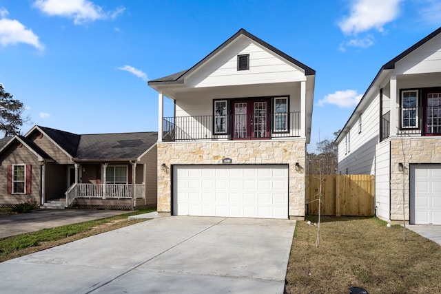 view of front of house with a front yard, a garage, and a porch