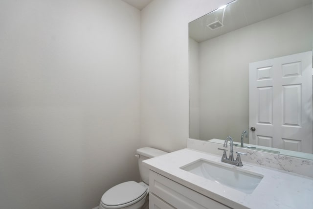 bathroom with toilet and vanity