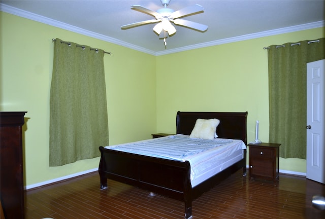 bedroom with crown molding, dark wood-type flooring, and ceiling fan