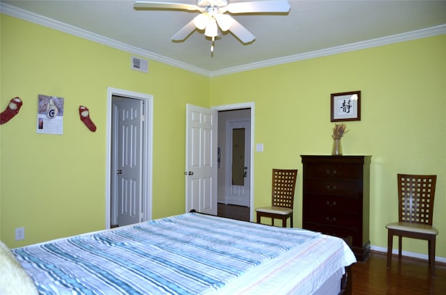 bedroom featuring ornamental molding, ceiling fan, and dark hardwood / wood-style floors