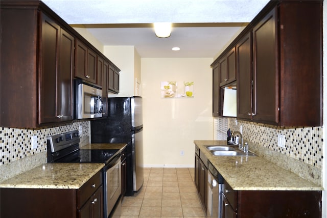 kitchen with stainless steel appliances, sink, backsplash, and light tile patterned flooring