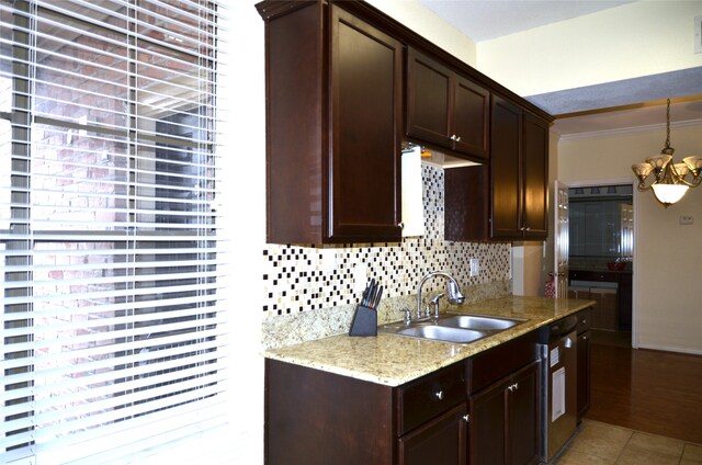 kitchen featuring crown molding, light hardwood / wood-style flooring, light stone counters, sink, and tasteful backsplash