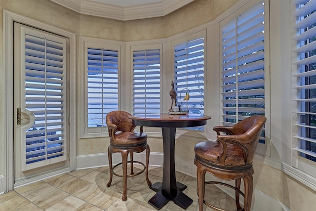 dining room with baseboards and ornamental molding