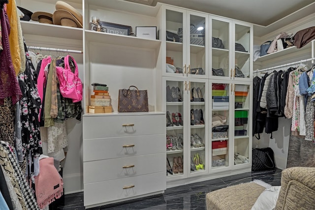 spacious closet featuring marble finish floor