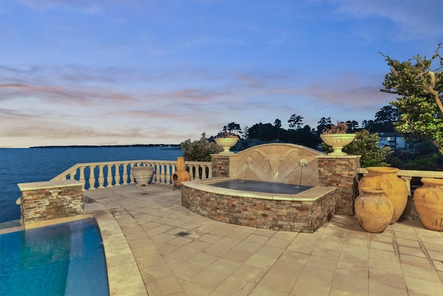 patio terrace at dusk with a water view