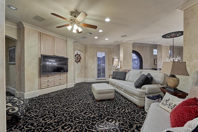 carpeted living room with a ceiling fan, baseboards, visible vents, arched walkways, and crown molding