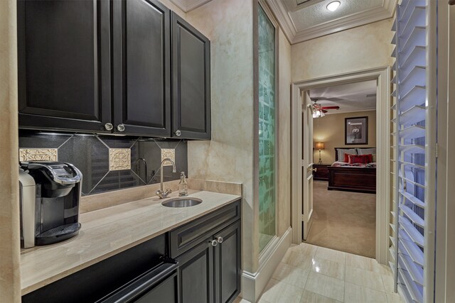 bathroom featuring ornamental molding, vanity, a shower, and ceiling fan