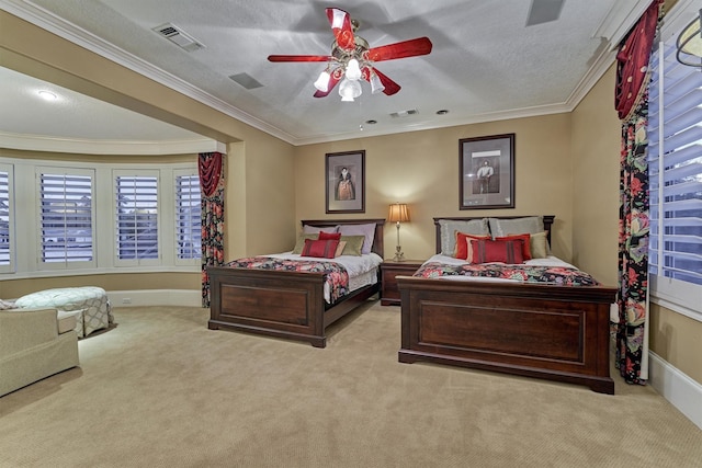 bedroom with visible vents, carpet floors, a textured ceiling, and crown molding