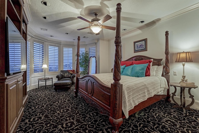 bedroom with visible vents, ornamental molding, a ceiling fan, a textured ceiling, and carpet