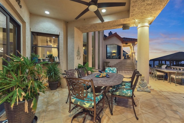 view of patio / terrace with outdoor dining area and ceiling fan