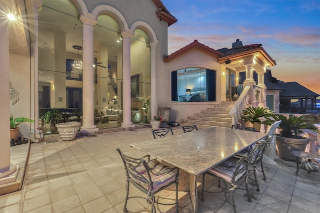 view of patio terrace at dusk