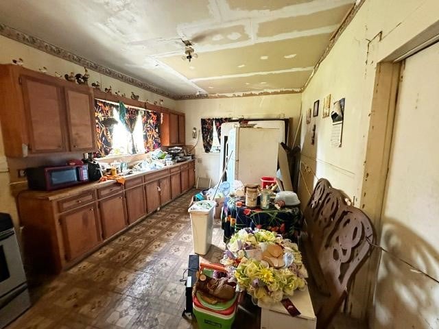 kitchen with tile patterned flooring and electric range