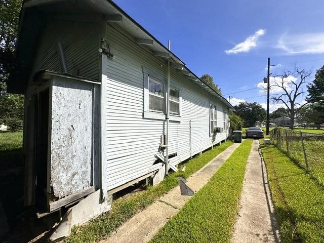 view of side of property with a yard