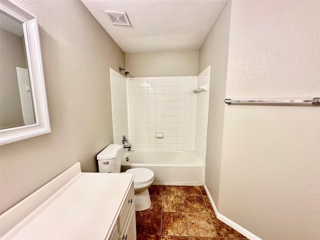 full bathroom with a textured ceiling, vanity, toilet, tiled shower / bath, and tile patterned floors