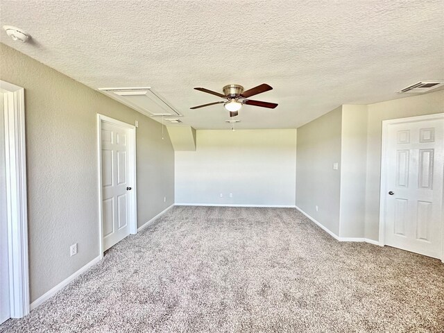 carpeted spare room with ceiling fan and a textured ceiling