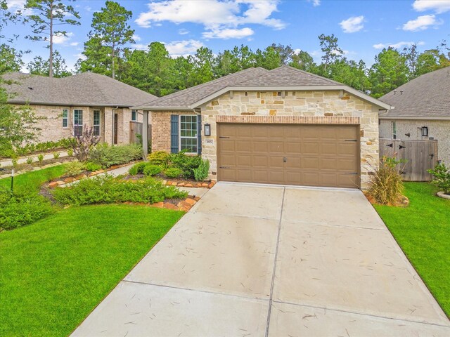 single story home featuring a garage and a front yard