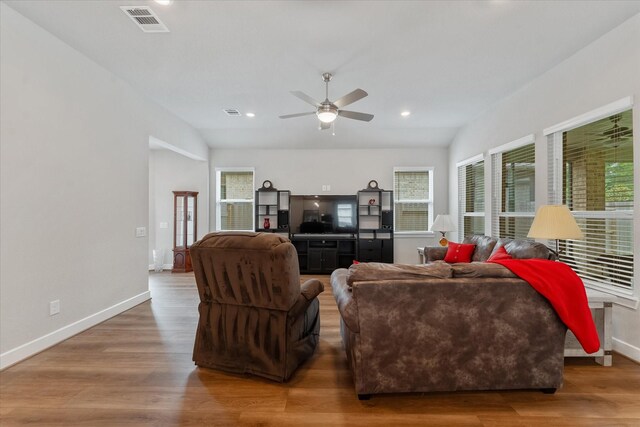 living room with vaulted ceiling, ceiling fan, and dark hardwood / wood-style floors