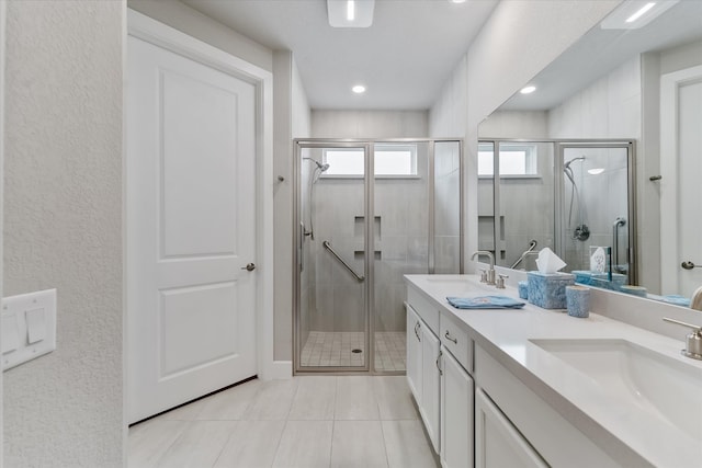 bathroom featuring vanity and a shower with door