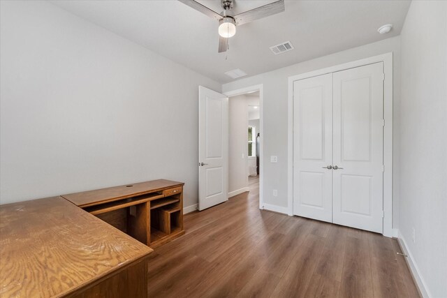 bedroom featuring hardwood / wood-style flooring, ceiling fan, and a closet