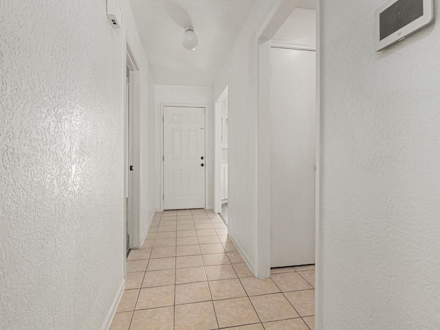 hall with light tile patterned flooring