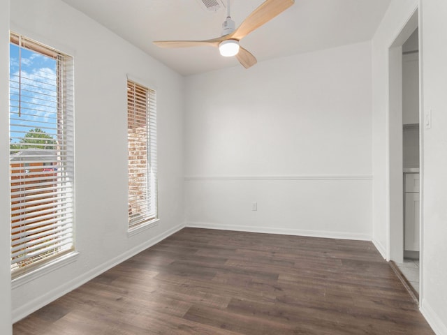 unfurnished room with dark wood-type flooring, plenty of natural light, and ceiling fan