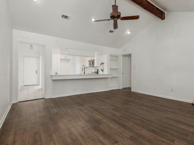 unfurnished living room with beamed ceiling, dark hardwood / wood-style flooring, high vaulted ceiling, and ceiling fan