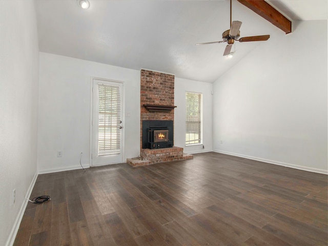 unfurnished living room featuring a fireplace, lofted ceiling with beams, brick wall, and dark hardwood / wood-style floors