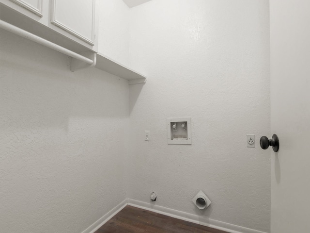 laundry area featuring dark hardwood / wood-style flooring, cabinets, gas dryer hookup, electric dryer hookup, and washer hookup