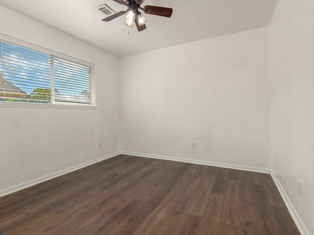 empty room with dark wood-type flooring and ceiling fan