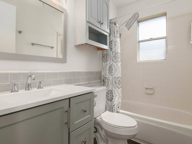 full bathroom featuring shower / bathtub combination with curtain, toilet, tile walls, tasteful backsplash, and vanity