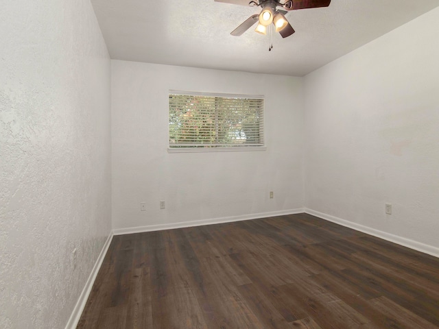 empty room featuring ceiling fan and dark hardwood / wood-style flooring