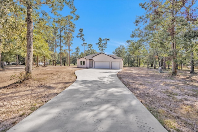 view of side of home with a garage and driveway