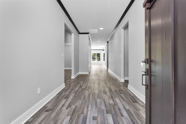 hall featuring crown molding and dark hardwood / wood-style floors