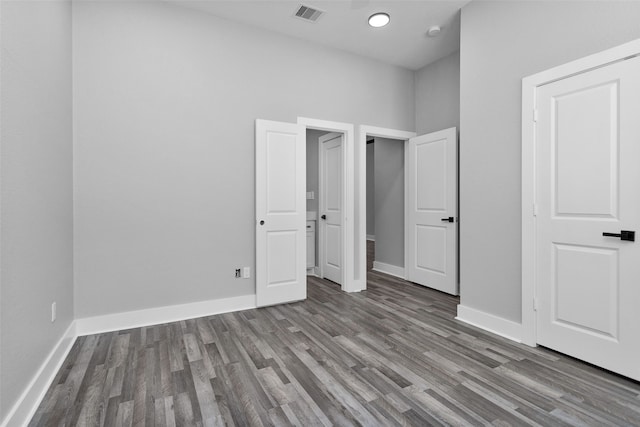 unfurnished bedroom featuring dark wood-type flooring