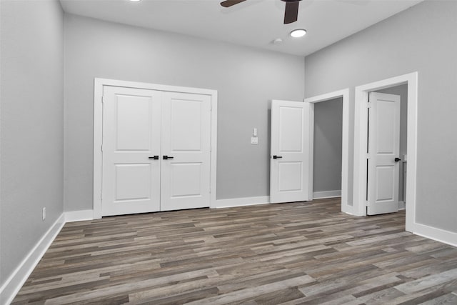 unfurnished bedroom featuring a closet, ceiling fan, and dark hardwood / wood-style floors