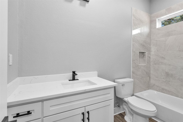 bathroom featuring toilet, wood finished floors, and vanity