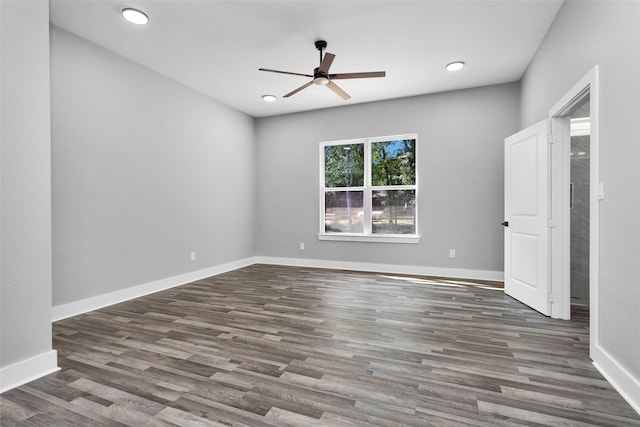 unfurnished room with ceiling fan and dark hardwood / wood-style flooring