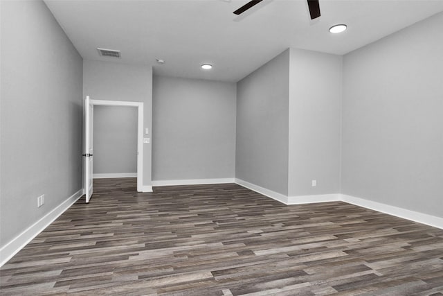 empty room featuring baseboards, ceiling fan, visible vents, and wood finished floors