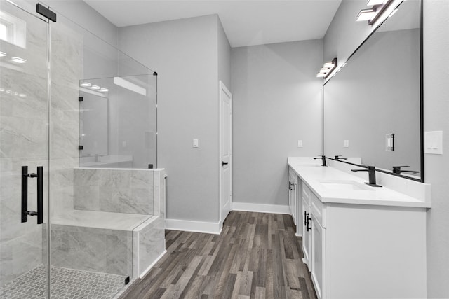 bathroom featuring an enclosed shower, hardwood / wood-style flooring, and vanity