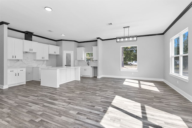 kitchen with white cabinets, plenty of natural light, and light hardwood / wood-style flooring