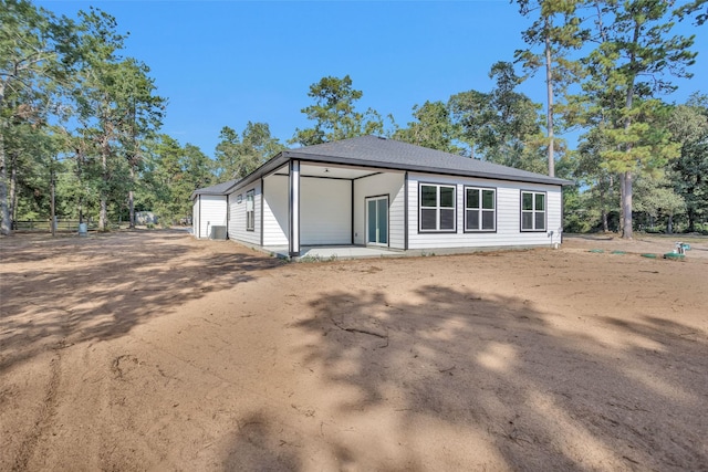 rear view of house featuring central AC unit and a patio