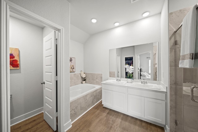 bathroom with vanity, hardwood / wood-style floors, and independent shower and bath