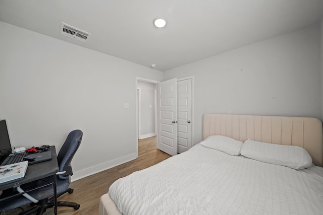 bedroom with dark wood-type flooring