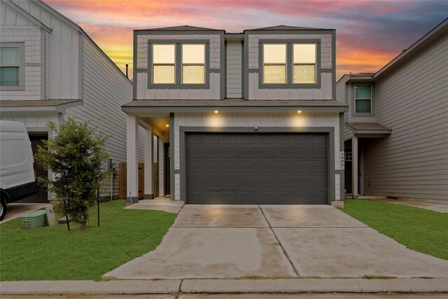 view of front facade with a garage and a lawn