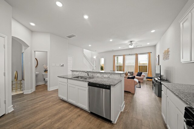 kitchen featuring dishwasher, sink, hardwood / wood-style flooring, ceiling fan, and white cabinets