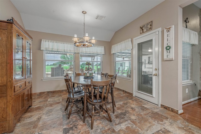 dining space featuring lofted ceiling, a chandelier, and tile patterned flooring