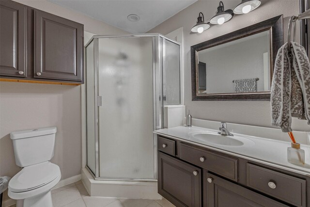 bathroom featuring vanity, toilet, walk in shower, and tile patterned floors