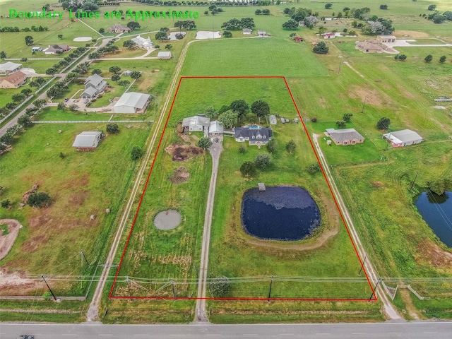 drone / aerial view with a water view and a rural view