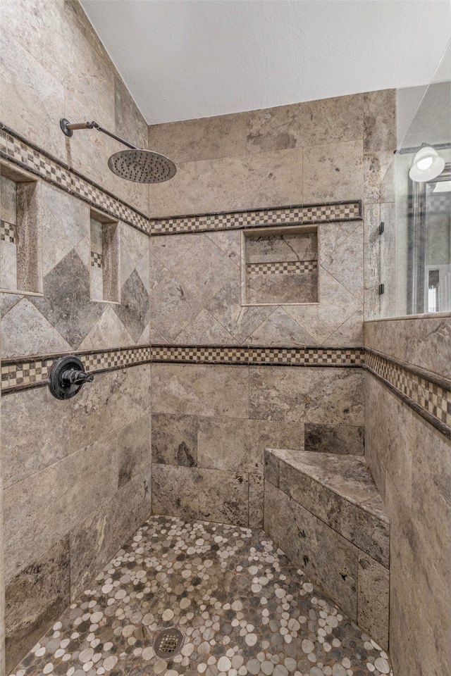 bathroom with a tile shower