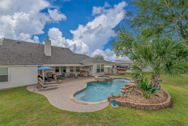 view of swimming pool with a lawn, a patio area, and an in ground hot tub